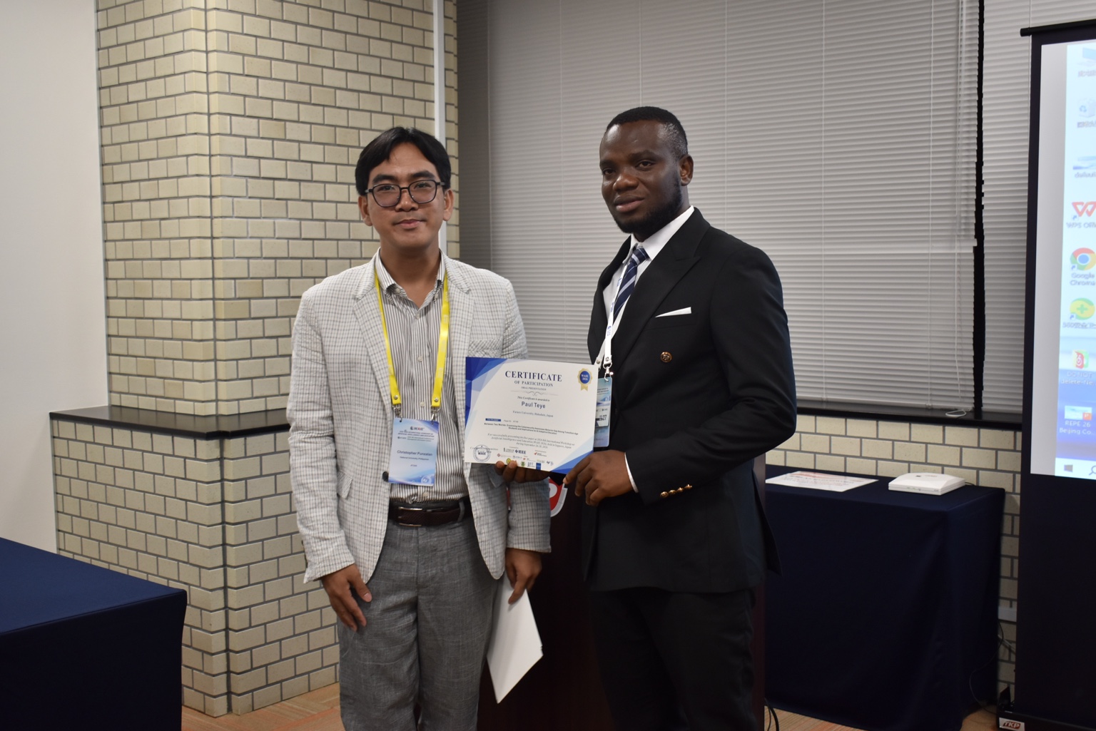 Paul Teye receiving a conference participation certificate